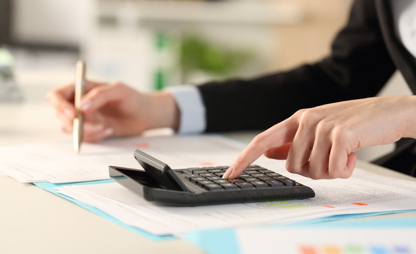 Executive hands calculating with calculator at the office