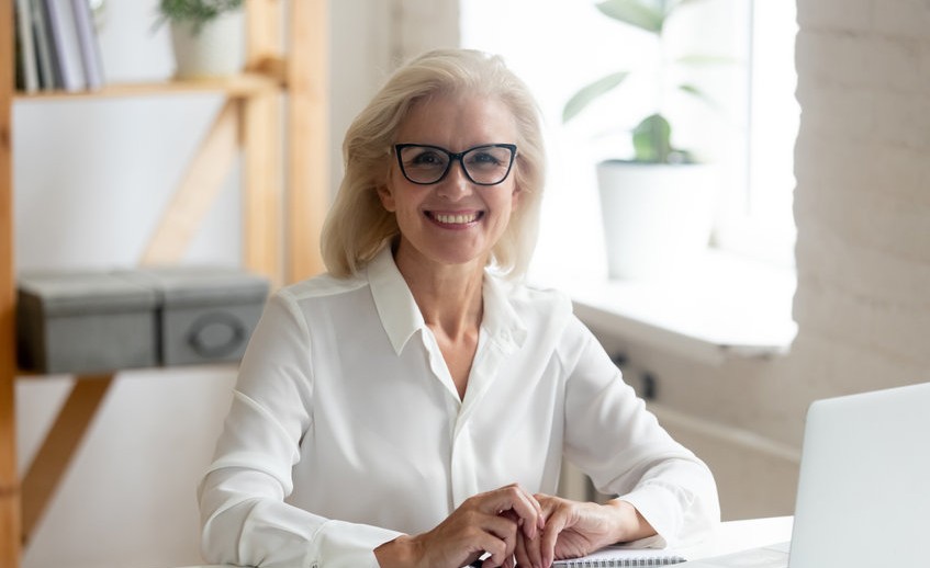 Portrait of smiling senior businesswoman posing at workplace