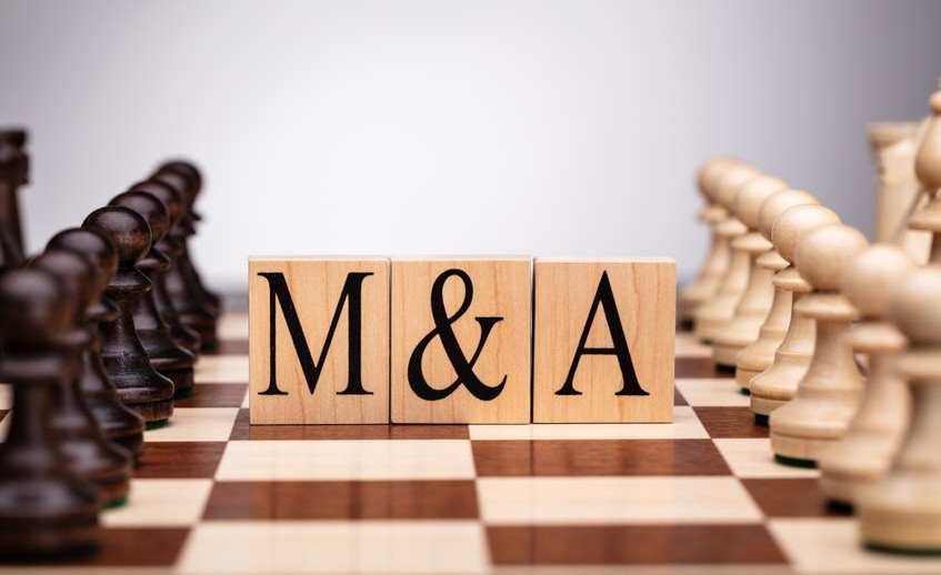 Wooden Blocks With Mergers And Acquisitions Text On Chess Board