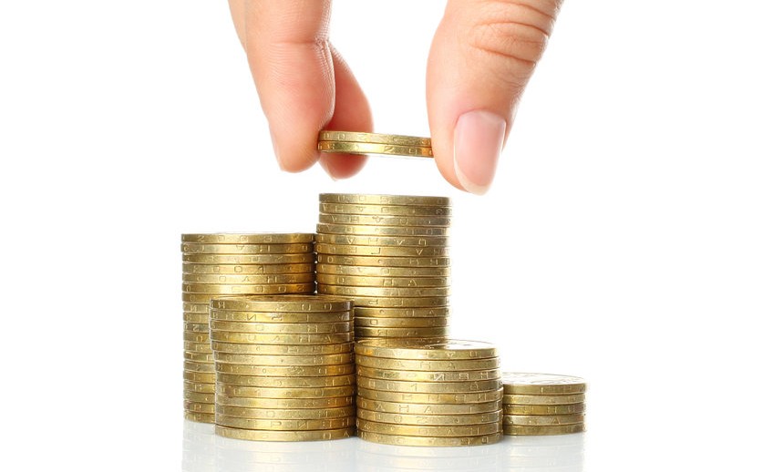 Hand put coins to stack of coins on white background